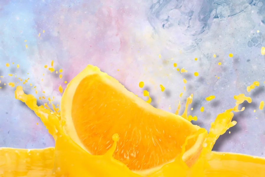 orange juice splashing with pastel background