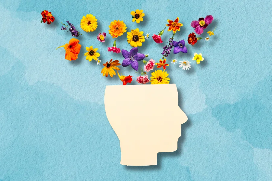 a collage of a head and flowers depicting mental health on blue pastel background