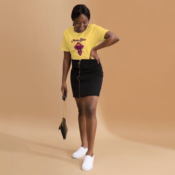 a woman wearing yellow magic mushroom t shirt, black skirt and white shoes